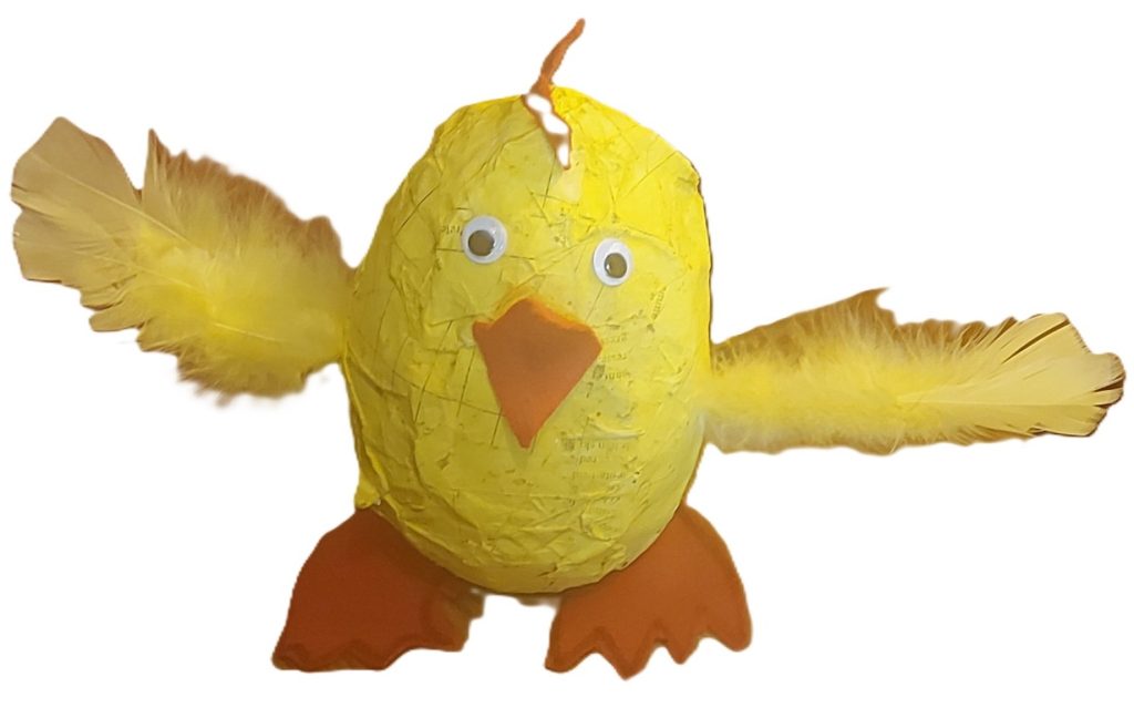 Papier-mâché chicken made from a balloon, painted yellow, with feather wings and orange felt beak and feet